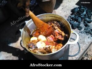 Woman Stirring Pots Over Fire, West Africa