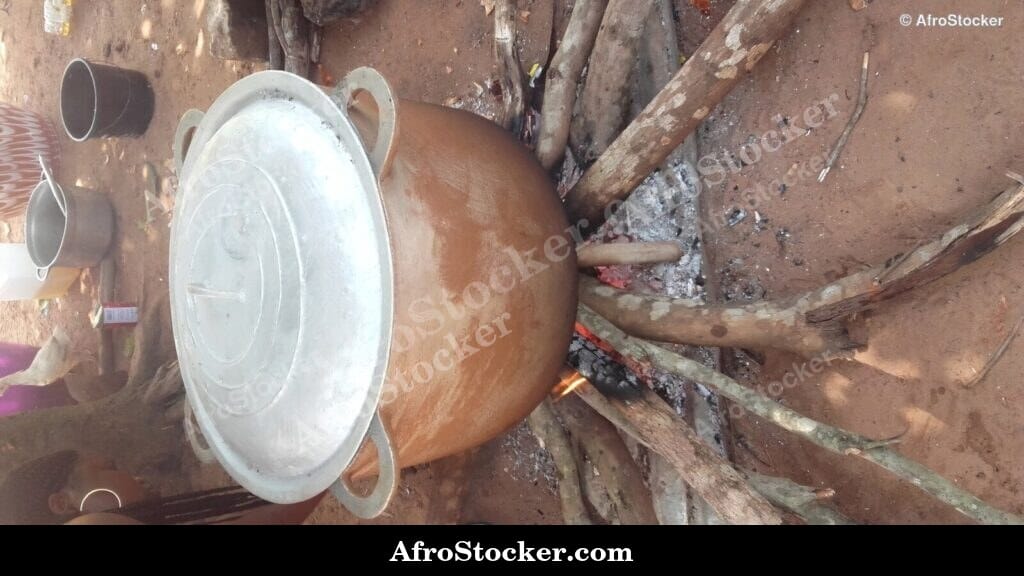 Rice Cooking in Large Pot Over Wood Fire - AfroStocker