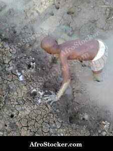 Child Playing In Mud Africa