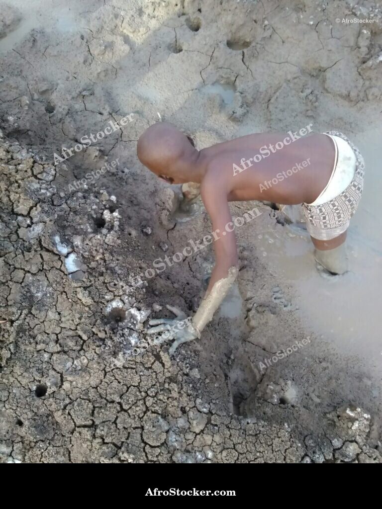 Child Playing In Mud Africa / Enfant dans la Boue Afrique | AfroStocker