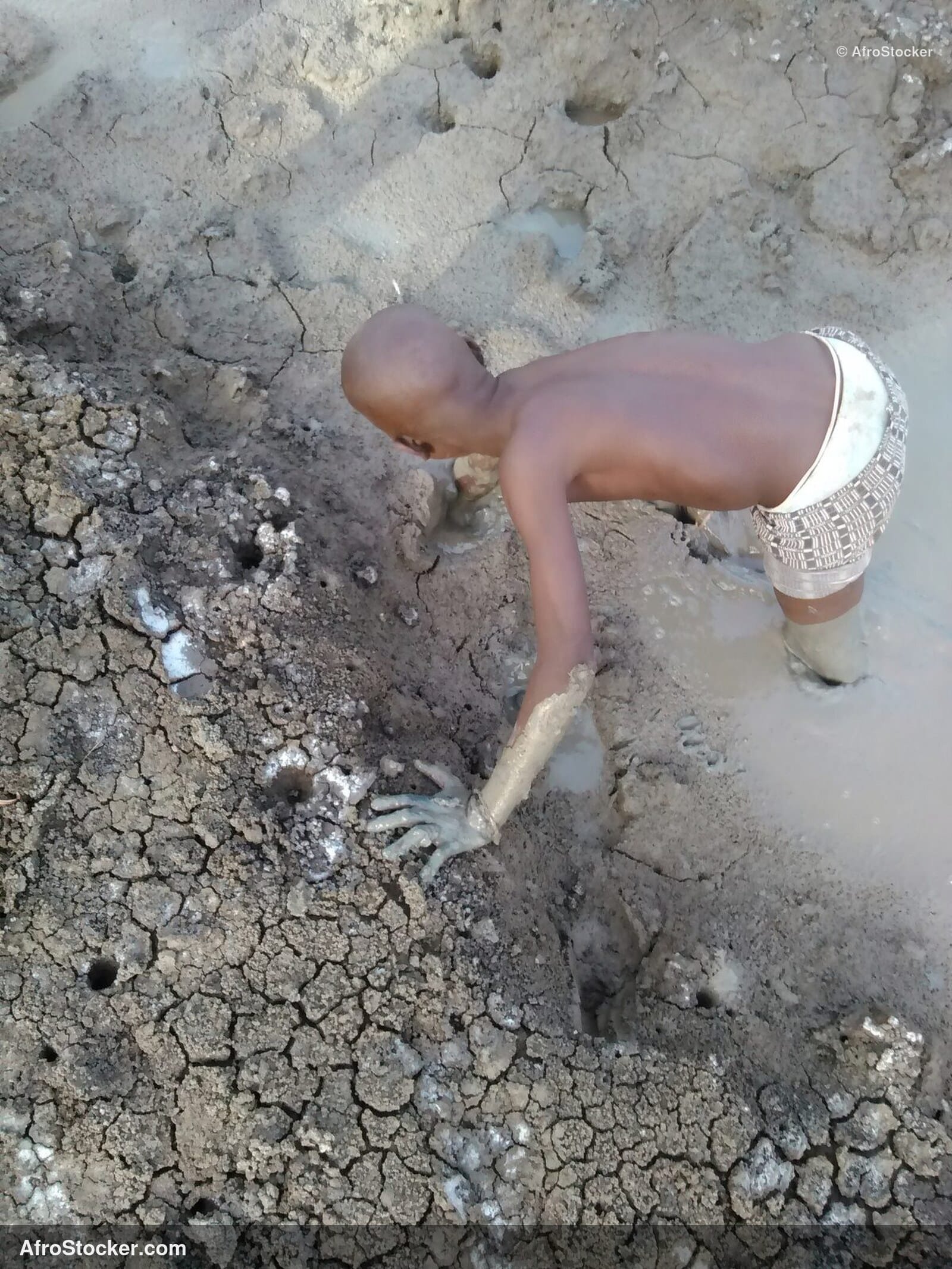 Child Playing In Mud Africa / Enfant dans la Boue Afrique | AfroStocker